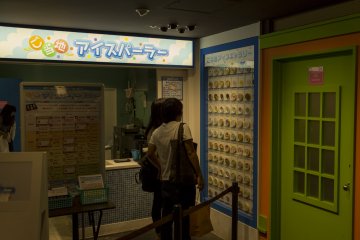 Two people choosing a treat or possibly some of the more disgusting flavours at the Regional Ice Cream Parlour at Namja Town Ikebukuro