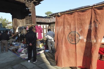 A vendor selling beautiful brown noren curtains
