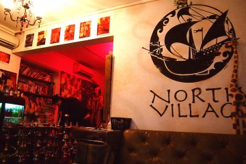 <p>The quirky interior of the cafe, also furnished with couches, coffee tables, and bookshelves stacked with books.</p>