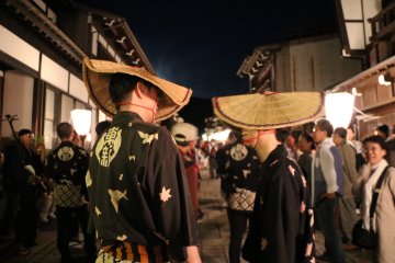 The face obscuring straw hats are a key component to the attire of participants
