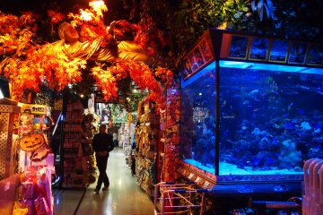 The entrance of Don Quijote gives you a wacky hint of what's in store. The Buddha's hand moves up and down, beseeching you to enter.
