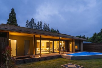 A hot spring bath and pool invite you outside, but warm and cosy lighting beckons you in