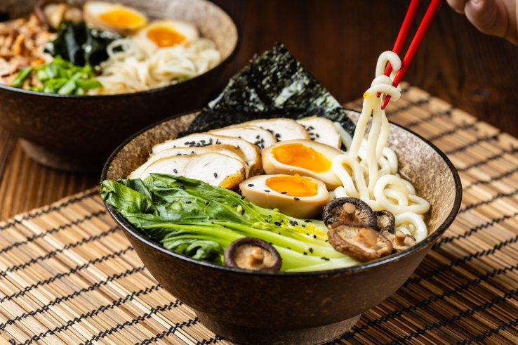 A bowl of ramen with chopsticks