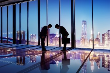 Japanese businessmen bowing to each other