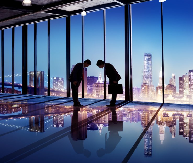 Japanese businessmen bowing to each other