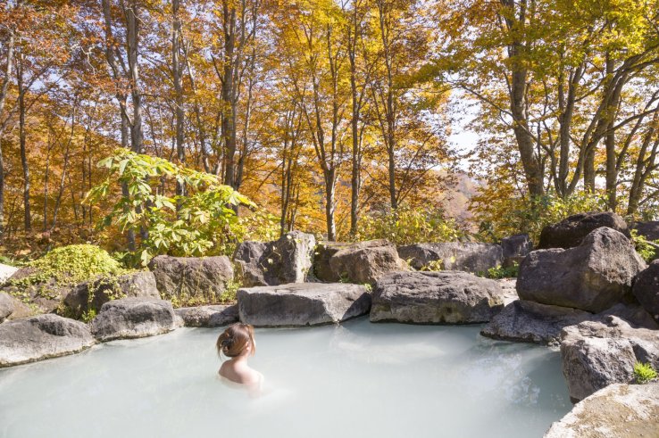 A woman relaxing in a Japanese onsen