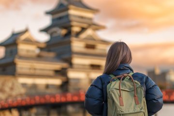 A solo traveler looking at Matsumoto Castle