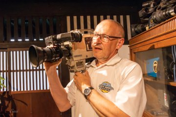Mr. Coyte explains the vintage cameras displayed in the café.