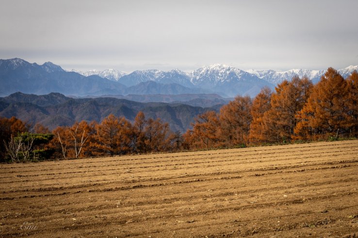 The Japanese Alps, with partial snow cover, appear in the background.
