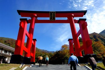 A large torii arch welcomes visitors to Yudonosan Shrine
