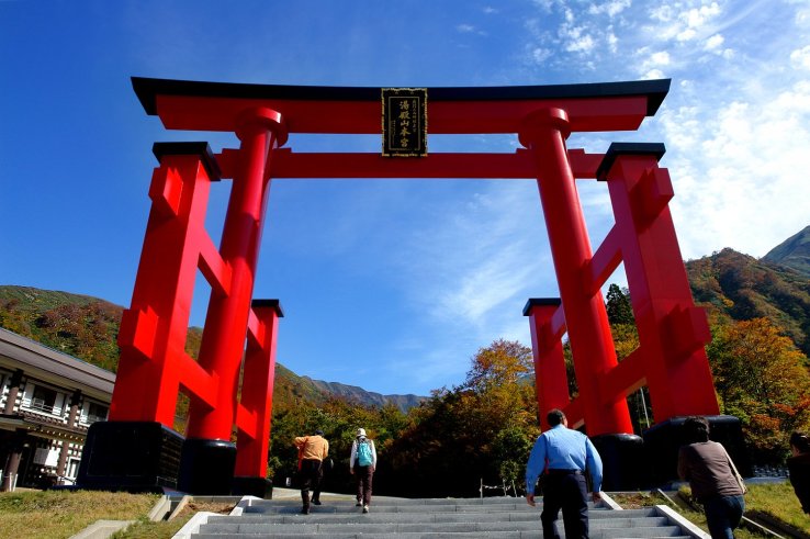 A large torii arch welcomes visitors to Yudonosan Shrine