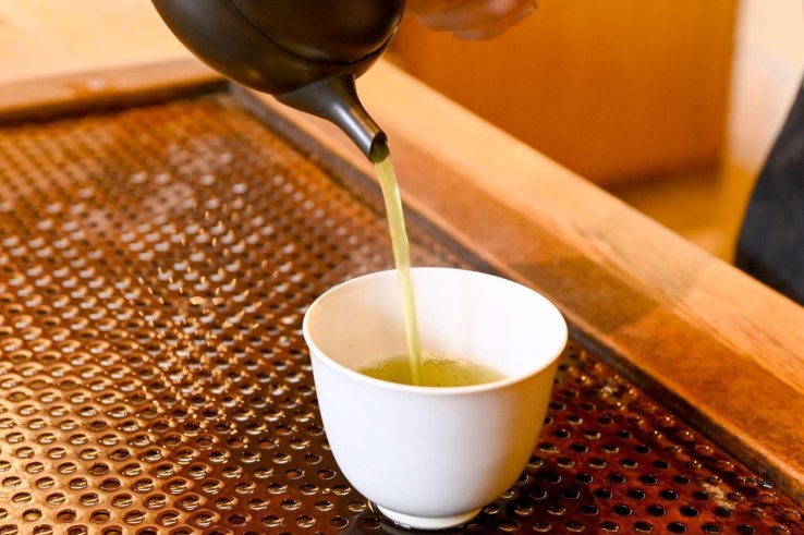 Green tea being poured