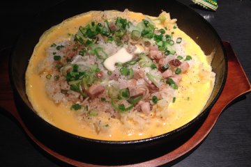 <p>the garlic fried rice arrives at the table looking just like this, steam still rising as it sizzles in front of you</p>