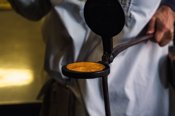 Handmade senbei in an iron mold