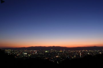 Last rays of light slip behind the city