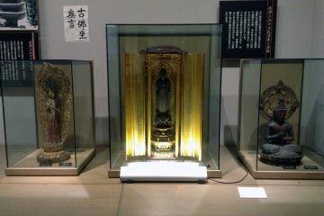 Buddhist figurines rest in a corner of the IDEHA commemorative hall.