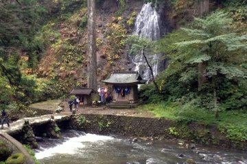 The walk up Mt. Haguro is filled with natural beauty. Before reaching the large pagoda you will traverse a bridge overlooking a waterfall.