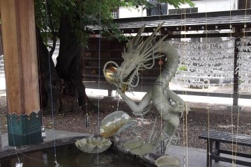 A fierce-looking dragon will watch you purify your hands
