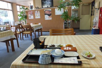 A VERY Japanese breakfast of rice, dried seaweed, soft-boiled egg, miso soup, grilled fish, and Japanese pickles