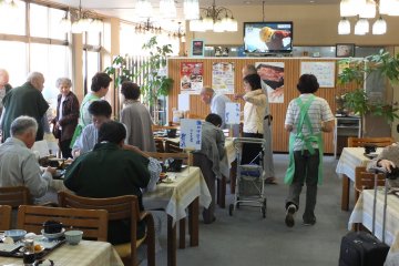 The breakfast dining room, full of happy guests, some of them wearing yukata
