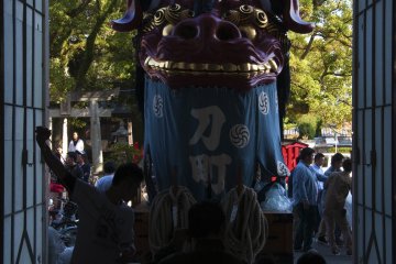 A few people doing maintenance of the "Hikiyama". They need everything to be perfect for the festival.