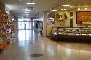 The first floor is lined with restaurants and shops.