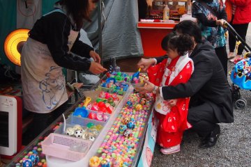 Booths selling cotton candy, crepes and cartoon masks as well as game booths were set up outside the entrance.