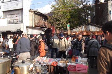 People strolling past the various products offered