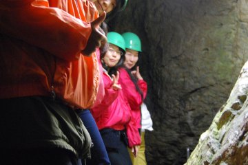 Visitors to Rokando wearing helmets, water-proof jackets and most importantly rubber boots, all provided on site.