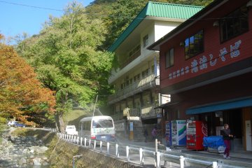 Rokando visitor center showing a glimpse of Kesen river and the green roofed dining hall.