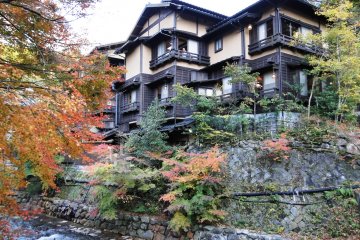 A ryokan against a backdrop of changing maples