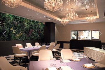 Dining area with full view of kitchen and chef