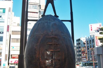 Boy and his baseball in front of the entrance