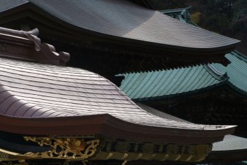 Roof of Hojo. It used to be the head priest’s living quarters, but is now a room for Za-zen training. Take of your shoes, and go into the building. A wooden walkway encircles the main room. A Zen garden sits in back of the room. There are several benches 