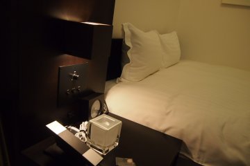 <p>Classy dark woody furnishing with clean white walls.</p>