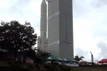<p>The Space Tower stretches towards the sky&nbsp;right alongside a model rocket used to launch satellites to the heavens.&nbsp;</p>