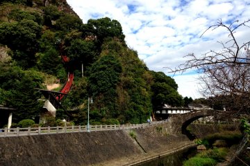 The Tsunagi Onsen with the private monorail car in the distance to the hot springs above the waterfall.