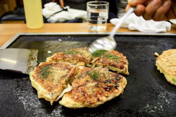 Finishing touches with seaweed powder and bonito flakes