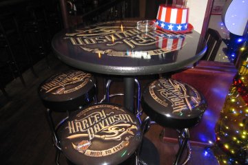 A table and high chairs with Harley-Davidson logo and a Stars & Stripes hat!?
