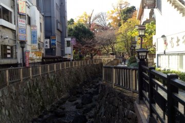 <p>A stream cuts through shops on a side street of the station.&nbsp;</p>