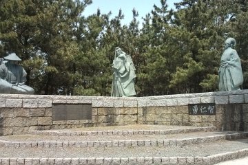 Statues of 3 main characters of Kabuki play 'Kanjincho' on the beach. From left, Yoshitsune, disguised as an itinerant ascetic; middle, Benkei, confronting Togashi; right, Togashi, the checkpoint guard master