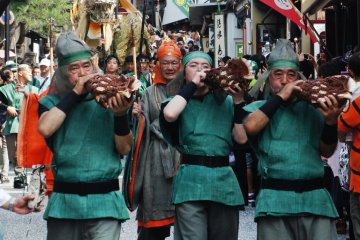 The dragon warriors play a traditional horn in a procession through the streets like the pied piper with the Seiryu-e behind them.