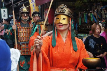 There's a woman warrior with eye catching custom bringing her grail. She splashes holy water to everyone who wants to be blessed.