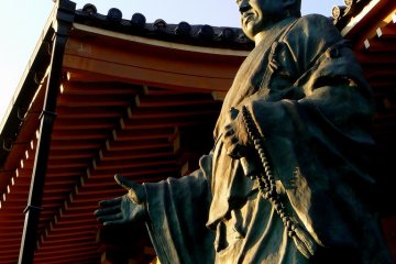 <p>A statue of a serene-faced monk overlooks the temple grounds</p>