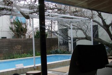 There is a pool outside the large window.