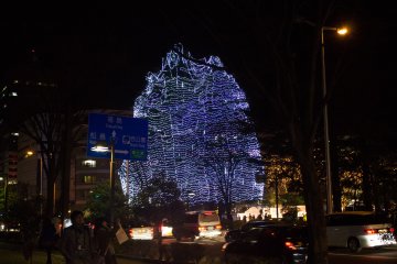 A towering tree full of lights marks the beginning of the Tunnel of Illumination.&nbsp;