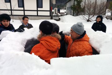 <p>The brave volunteers are nearly locked inside the soon to be finished igloo.&nbsp;</p>