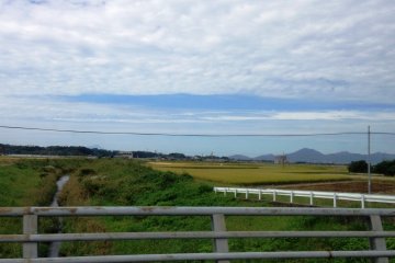 The countryside on the way to Mamedacho is a contrast between open fields and green mountains