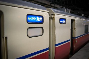 Moonlight Kyushu Carriages with signs in Japanese