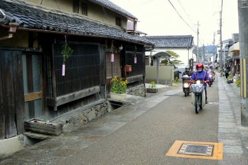 <p>A posse of scooters cruise down Takatori-cho's main street</p>